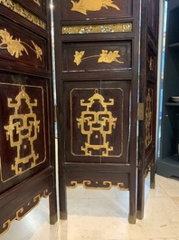 A Chinese four-part reticulated and partially gilt wooden folding screen, 19th C.