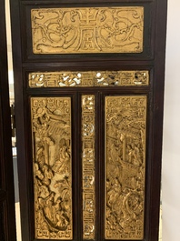 A Chinese four-part reticulated and partially gilt wooden folding screen, 19th C.