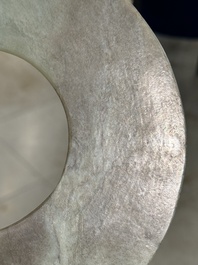 A Chinese celadon and russet jade 'bi' disc, Neolithic period