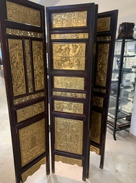 A Chinese four-part reticulated and partially gilt wooden folding screen, 19th C.