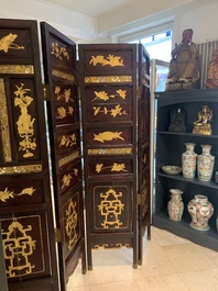 A Chinese four-part reticulated and partially gilt wooden folding screen, 19th C.