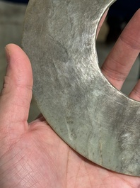 A Chinese celadon and russet jade 'bi' disc, Neolithic period