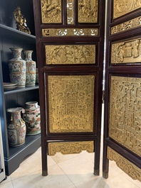 A Chinese four-part reticulated and partially gilt wooden folding screen, 19th C.