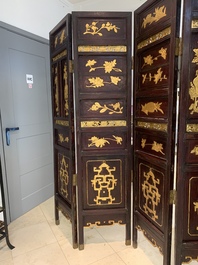 A Chinese four-part reticulated and partially gilt wooden folding screen, 19th C.