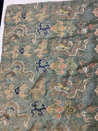 A Chinese green-ground embroidered silk panel with dragons among clouds, 18th C.