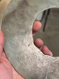 A Chinese celadon and russet jade 'bi' disc, Neolithic period