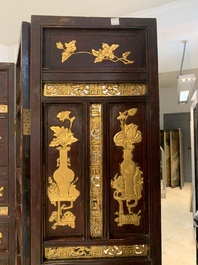A Chinese four-part reticulated and partially gilt wooden folding screen, 19th C.