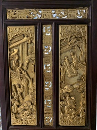 A Chinese four-part reticulated and partially gilt wooden folding screen, 19th C.
