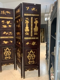 A Chinese four-part reticulated and partially gilt wooden folding screen, 19th C.