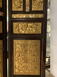 A Chinese four-part reticulated and partially gilt wooden folding screen, 19th C.
