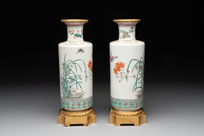A pair of Chinese famille rose gilt-bronze-mounted 'birds among flowering branches' vases, 19th C.