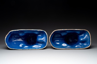 A pair of white-decorated blue-ground faience models of reclining lions, Nevers, 18th C.