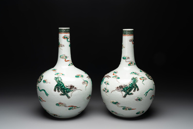 A pair of Chinese famille verte relief-decorated 'animals' vases, 19th C.