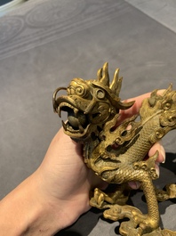 A pair of Chinese gilt bronze dragons among flames and clouds, 19/20th C.