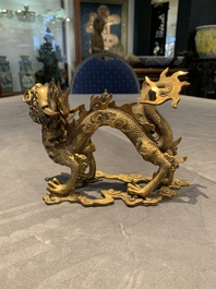 A pair of Chinese gilt bronze dragons among flames and clouds, 19/20th C.