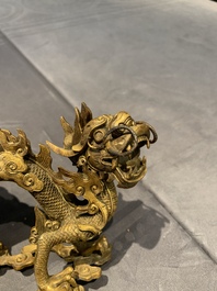A pair of Chinese gilt bronze dragons among flames and clouds, 19/20th C.