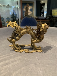 A pair of Chinese gilt bronze dragons among flames and clouds, 19/20th C.