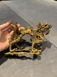 A pair of Chinese gilt bronze dragons among flames and clouds, 19/20th C.