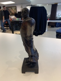A fine Chinese bronze Luohan holding a sutra, Ming