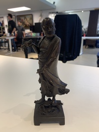 A fine Chinese bronze Luohan holding a sutra, Ming