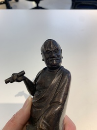 A fine Chinese bronze Luohan holding a sutra, Ming