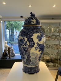 A massive Japanese blue and white Arita vase and cover with an eagle, a shishi and cub, 19th C.