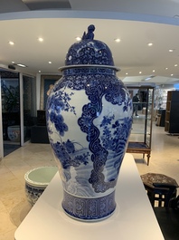 A massive Japanese blue and white Arita vase and cover with an eagle, a shishi and cub, 19th C.