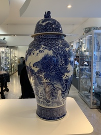 A massive Japanese blue and white Arita vase and cover with an eagle, a shishi and cub, 19th C.