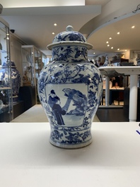 A pair of Chinese blue and white vases and covers with figural panels, 19th C.