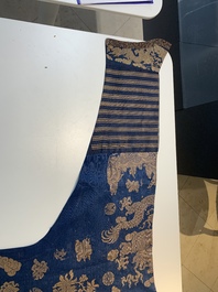 A Chinese embroidered silk blue-ground summer gauze 'nine dragons' robe, 19th C.