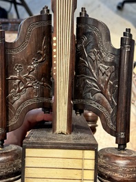 A large Chinese carved wooden table screen with a fine famille rose 'landscape' plaque, 19th C.