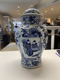 A pair of Chinese blue and white vases and covers with figural panels, 19th C.