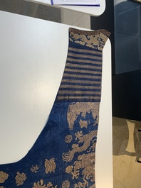 A Chinese embroidered silk blue-ground summer gauze 'nine dragons' robe, 19th C.