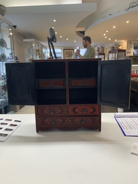 A Chinese cinnabar lacquer 'mountainous landscape' cabinet, 19th C.