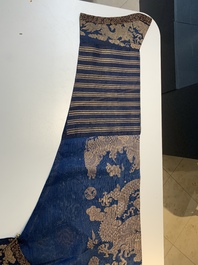 A Chinese embroidered silk blue-ground summer gauze 'nine dragons' robe, 19th C.