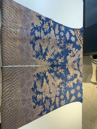 A Chinese embroidered silk blue-ground summer gauze 'nine dragons' robe, 19th C.