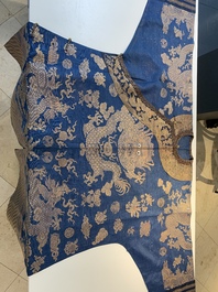 A Chinese embroidered silk blue-ground summer gauze 'nine dragons' robe, 19th C.