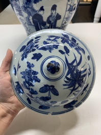 A pair of Chinese blue and white vases and covers with figural panels, 19th C.