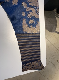 A Chinese embroidered silk blue-ground summer gauze 'nine dragons' robe, 19th C.