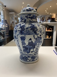 A pair of Chinese blue and white vases and covers with figural panels, 19th C.