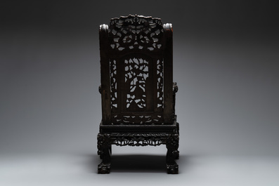 A Chinese richly carved and lacquered hongmu armchair, Canton, 19th C.