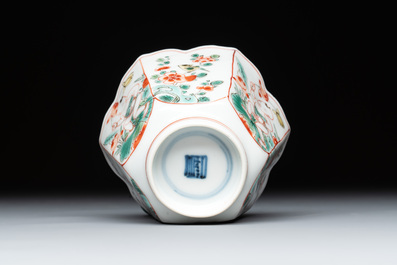 A fine Chinese famille verte 'boy and lotus' flower-shaped cup and a wooden stand, Kangxi