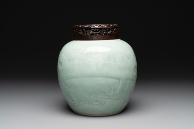 A Chinese celadon-glazed 'dragon' jar with reticulated wooden cover and stand, Qianlong