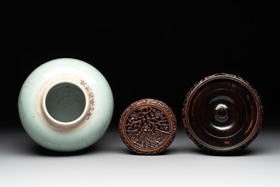 A Chinese celadon-glazed 'dragon' jar with reticulated wooden cover and stand, Qianlong