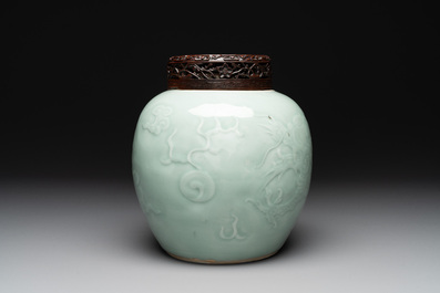 A Chinese celadon-glazed 'dragon' jar with reticulated wooden cover and stand, Qianlong