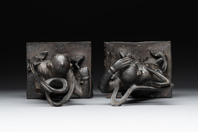 A pair of Chinese bronze guardians on stands, 17/18th C.