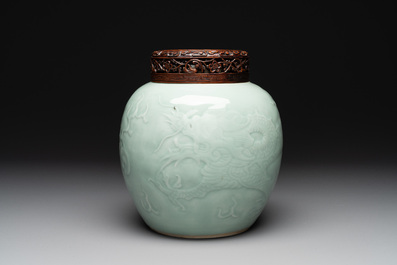 A Chinese celadon-glazed 'dragon' jar with reticulated wooden cover and stand, Qianlong