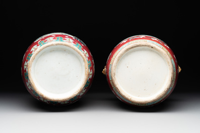 A pair of Chinese famille rose ruby-ground 'landscape' vases, 19th C.