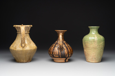 Two Chinese brown-glazed ewers and a celadon-glazed vase, one ewer dated 1571 with a Longqing mark, Qing