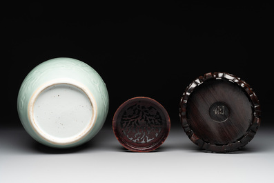 A Chinese celadon-glazed 'dragon' jar with reticulated wooden cover and stand, Qianlong